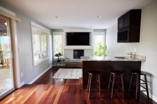 a kitchen with a counter and stools in a room at Lake View - Private - Spacious in Renton