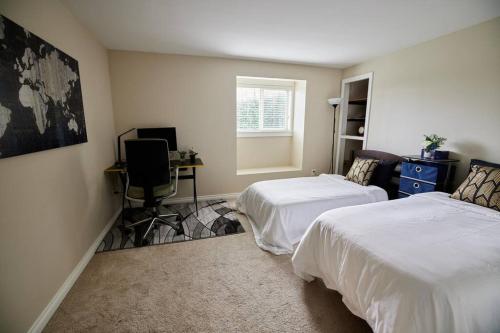 a bedroom with two beds and a desk and a window at Lake View - Private - Spacious in Renton