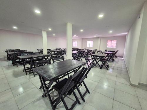 a group of tables and chairs in a room at Atlântico Sul Hotel in Porto De Galinhas