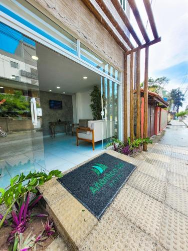 a house with a welcome mat on the front porch at Atlântico Sul Hotel in Porto De Galinhas