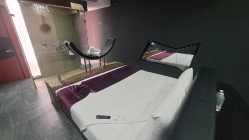 a bedroom with two beds and a mirror and a sink at Playme in Querétaro