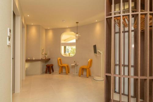 a hallway with chairs and a table and a mirror at The First Gwangan in Busan