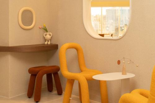 a room with chairs and a table and a mirror at The First Gwangan in Busan