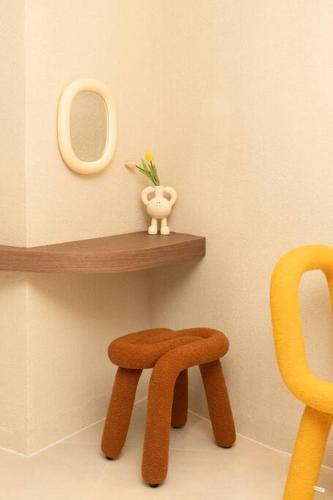a wooden stool and a mirror on a shelf at The First Gwangan in Busan