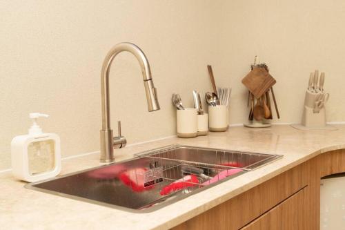 a kitchen counter with a sink and utensils at The First Gwangan in Busan