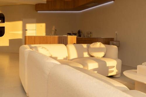 a living room with a white couch and a chair at The First Gwangan in Busan