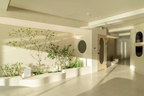 a hallway with plants on the wall in a building at The First Gwangan in Busan