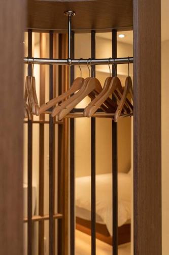 a black bunk bed with wooden hangers in a room at The First Gwangan in Busan