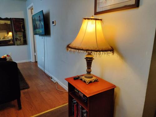 a lamp sitting on top of a wooden table at Stylish and Beautiful Condo in Frederick