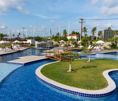a large pool with blue water in a resort at Muro alto condomínio clube in Ipojuca