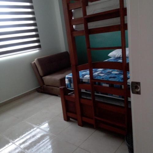 Llit o llits en una habitació de Departamento Alfredd