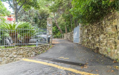 a road with a gate and a stone wall at 1 Bedroom Nice Apartment In Recco in Recco