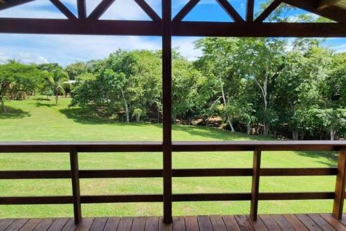 a porch with a view of a green yard at The Modern Cabin in Spanish Lookout
