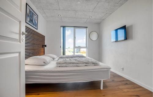 a white bedroom with a bed and a window at Beautiful Home In Børkop With Kitchen in Børkop