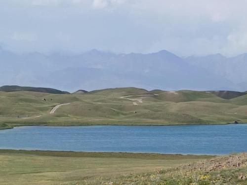 a large body of water with mountains in the background at Nice Yurt Camp in Sary-Mogul
