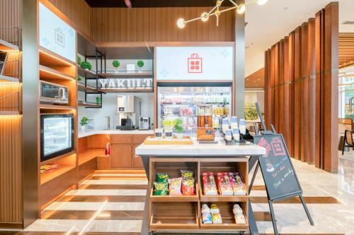 a store with a counter with food on it at Hilton Garden Inn Hangzhou Xixi Zijingang in Hangzhou