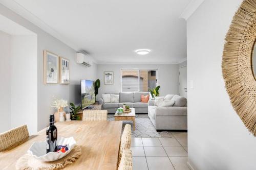a living room with a couch and a table at Stones throw to Grammar, Queens Park & CDB! in Toowoomba