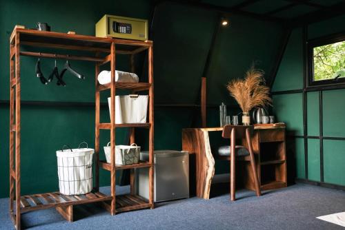 a room with shelves and a green wall at Villa Hillcrest in Weligama