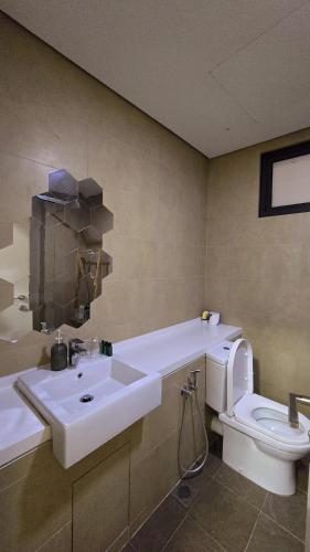 a bathroom with a sink and a toilet at Radia Residence Bukit Jelutong, Shah Alam by Emerald in Shah Alam