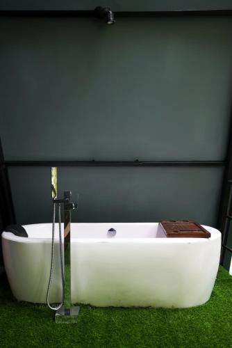 a white bath tub sitting in the grass at Villa Hillcrest in Weligama