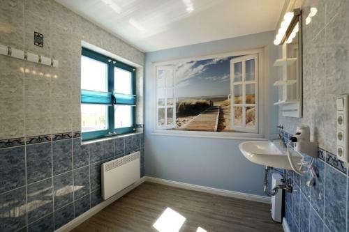 a bathroom with a sink and a window at MP 8 Steuerbord in Steinbeck