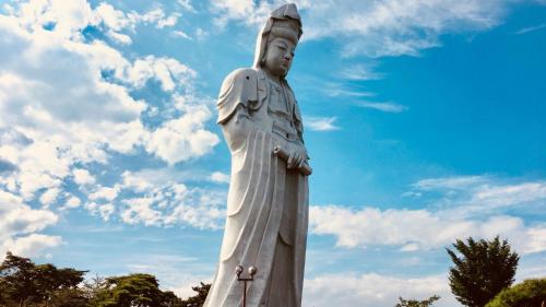 a statue of a woman standing in front of a blue sky at Toyoko Inn Takasaki eki Nishi guchi No 1 in Takasaki