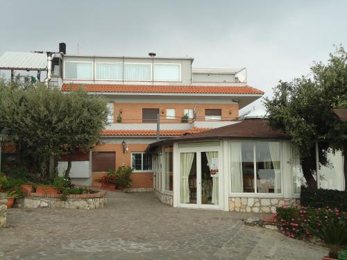 a large building with a patio in front of it at Pensione Campese in Formia