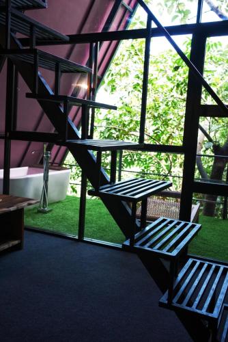 two benches sitting in front of a window at Villa Hillcrest in Weligama