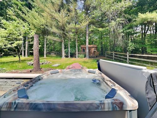 a jacuzzi tub sitting on top of a patio at Wander Through the Woods in McHenry