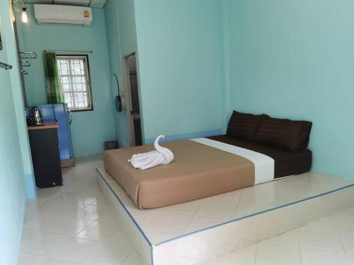 a bedroom with a bed with a white bird on it at ฺBaan Rai Ing Doi in Chaiyaphum