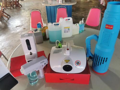 a table with a sewing machine and other items on it at ฺBaan Rai Ing Doi in Chaiyaphum