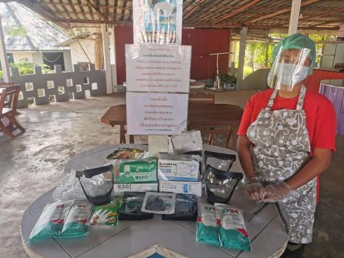 a woman standing in front of a table withmedical supplies at ฺBaan Rai Ing Doi in Chaiyaphum