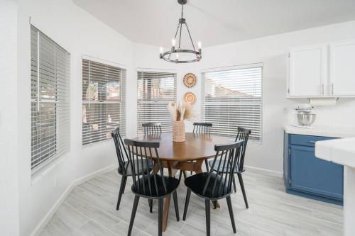 a dining room with a wooden table and chairs at Sonoran Sunspot, Quiet Neighborhood, Sunroom in Glendale