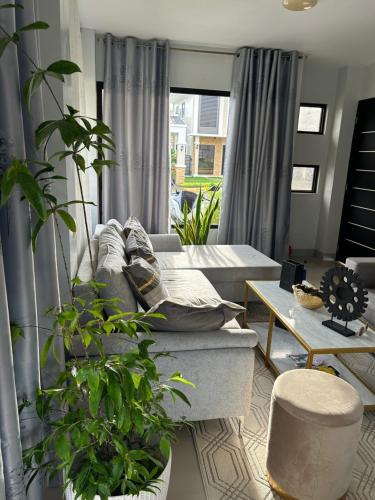 a living room with a couch and some plants at Casa Almera in Totolan