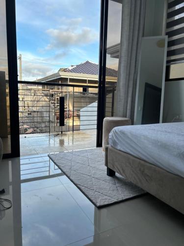 a bedroom with a bed and a view of a balcony at Casa Almera in Totolan