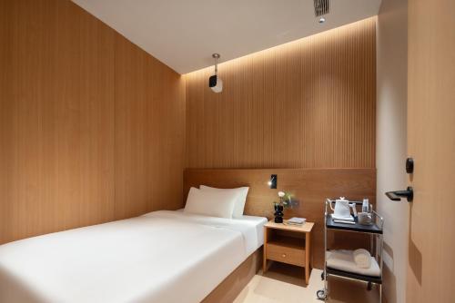 a hotel room with a bed and a table at Shanghai Captain 5 Youth Hotel - Xinzhuang Metro Station in Shanghai