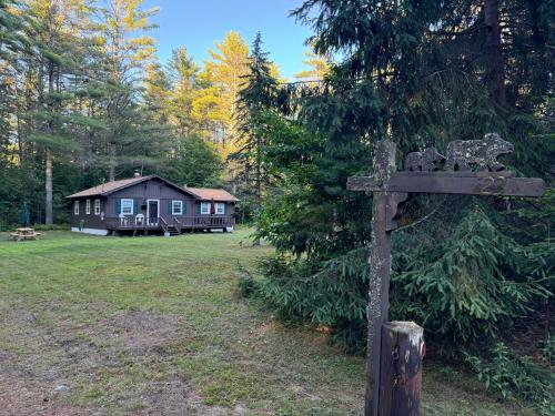 a sign in front of a house with a cabin at Mossy Bear Retreat in Chestertown