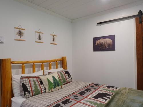 a bedroom with a bed with a comforter and pillows at Mossy Bear Retreat in Chestertown