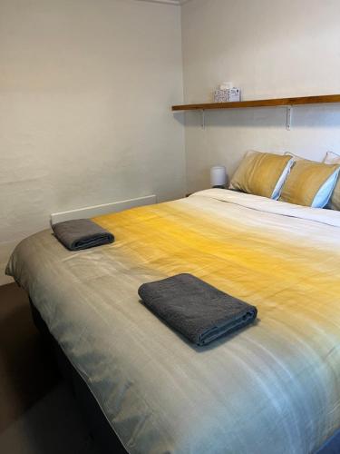 a bed with two towels sitting on top of it at Ripparoo Lodge in Falls Creek
