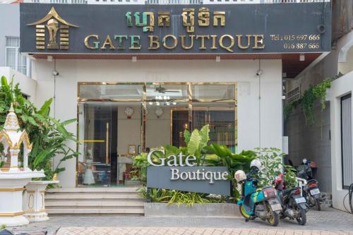 two scooters parked in front of a cafe boutique at Kampot Gate Boutique in Kampot