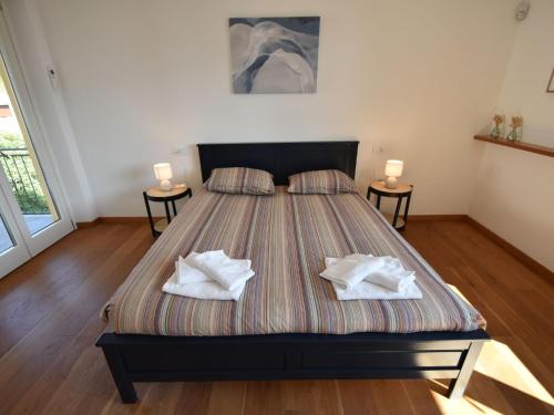 a bedroom with a bed with two pillows on it at Apartment in a prime location on Lake Maggiore in Verbania