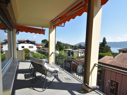 a balcony with two chairs and a view of the water at Apartment in a prime location on Lake Maggiore in Verbania