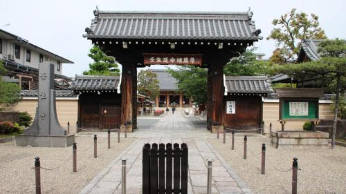 an entrance to a building with a gate at Toyoko Inn Kyoto Gojo omiya in Kyoto