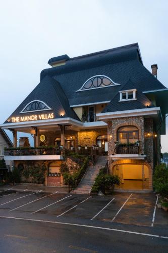 a building with a sign that reads the manker villas at The Manor Villas Da Lat in Xuan An