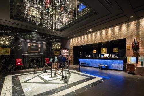 a room with a fireplace and a chandelier at Hotel Monterey Kyoto in Kyoto