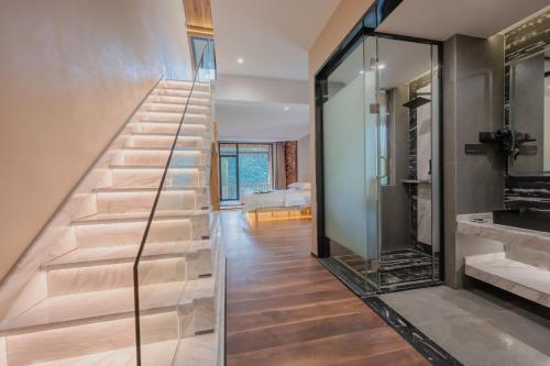 a staircase in a house with glass walls at 雾里观阵山 Foggy Valley in Zhangjiajie