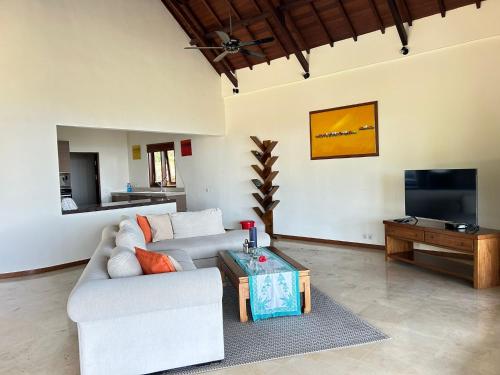 a living room with a couch and a coffee table at Villa Ponjok Batu Residence in Bukti