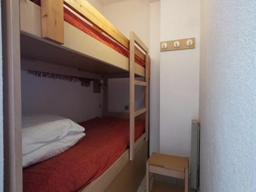 - une petite chambre avec 2 lits superposés et une chaise dans l'établissement Studio cabine 4 pers, plage à 10m, parking, clim, WiFi, animaux acceptés - FR-1-803-63, au Lavandou