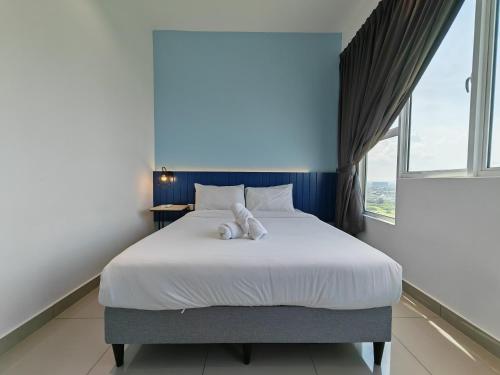 Un pat sau paturi într-o cameră la Mykey Amber Cove A-23-25 Melaka City