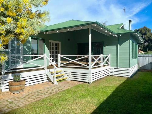 a green and white house with a porch at Town Hideaway - Sleeps 6 in Margaret River Town